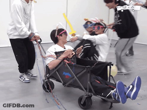 A Group Of People Are Playing With A Wagon That Says ' Nike ' On The Front GIF