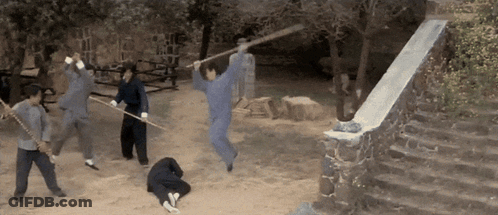 A Group Of People Are Playing With Sticks In A Field GIF