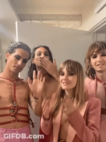 A Group Of People Are Posing For A Picture And One Of Them Has A Tattoo On His Chest That Says " Allow Dream " . GIF