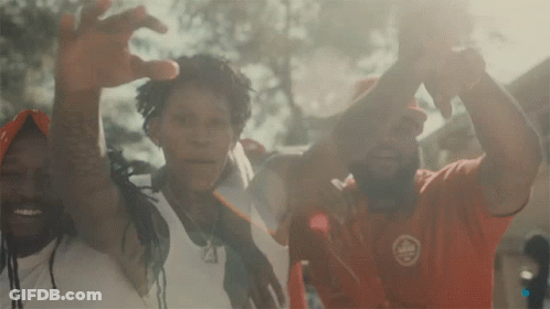 A Group Of People Are Posing For A Picture And One Of Them Is Wearing A Red Shirt That Says ' Canada ' On It GIF