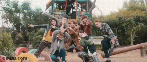 A Group Of People Are Posing For A Picture In A Playground . GIF