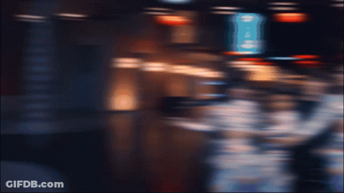 A Group Of People Are Posing For A Picture In Front Of A Sign That Says ' George 'S ' GIF