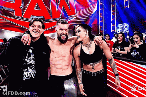A Group Of People Are Posing For A Picture In Front Of A Sign That Says Raw GIF