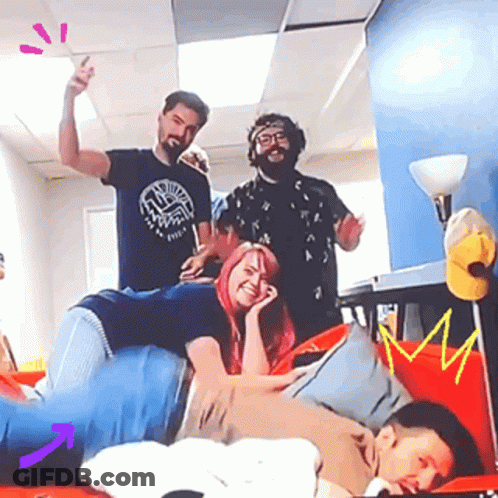 A Group Of People Are Posing For A Picture Together . GIF