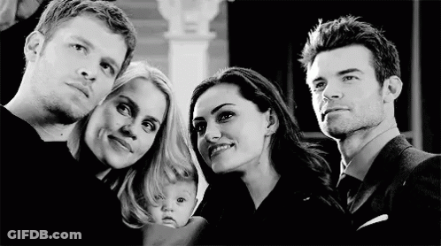 A Group Of People Are Posing For A Picture Together . GIF