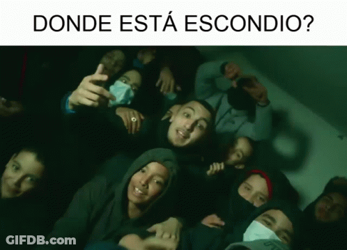 A Group Of People Are Posing For A Picture With The Words " Donde Esta Escondido " Above Them GIF