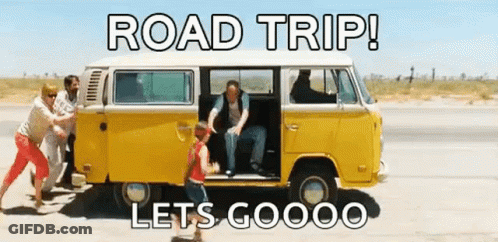 A Group Of People Are Pushing A Yellow Van On The Side Of The Road . GIF