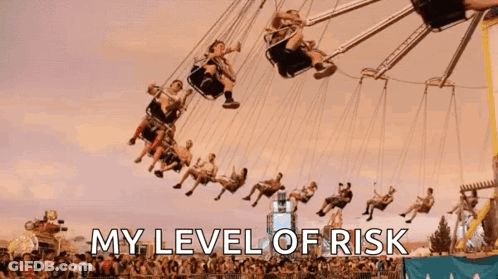 A Group Of People Are Riding A Merry Go Round At An Amusement Park With The Words " My Level Of Risk " Above Them GIF