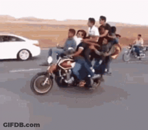 A Group Of People Are Riding A Motorcycle On A Highway . GIF