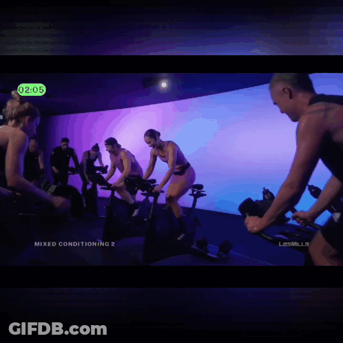 A Group Of People Are Riding Exercise Bikes With The Words Pussycats Or Cheaters At The Bottom GIF
