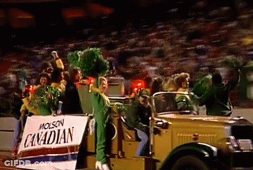 A Group Of People Are Riding In A Car With A Sign That Says Canadian On It . GIF