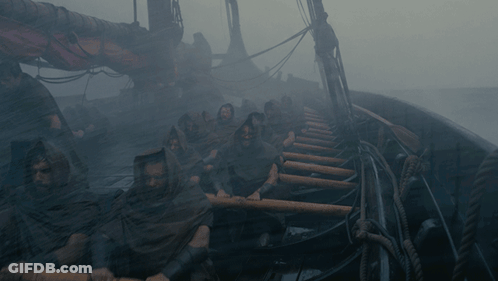 A Group Of People Are Rowing A Boat In The Water GIF