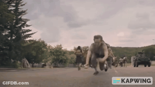 A Group Of People Are Running Down A Street With A Kapwing Logo In The Corner GIF