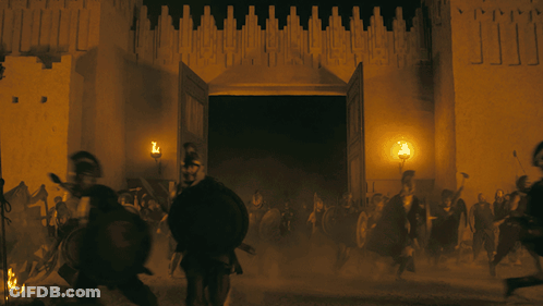 A Group Of People Are Running In Front Of A Building With The Doors Open GIF