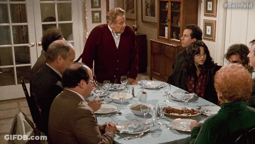 A Group Of People Are Sitting Around A Table With #Seinfeld Written On The Bottom Right GIF