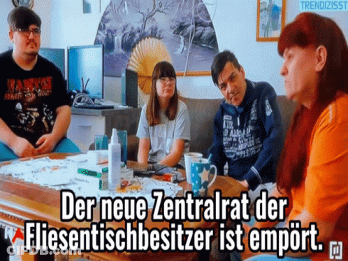 People Sitting Around Table With Caption GIF