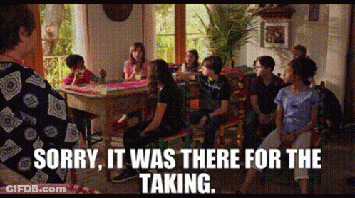 A Group Of People Are Sitting Around A Table With The Words Sorry It Was There For The Taking On The Bottom GIF