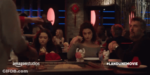 A Group Of People Are Sitting At A Table In A Restaurant With Amazonstudios Written On The Bottom Right GIF