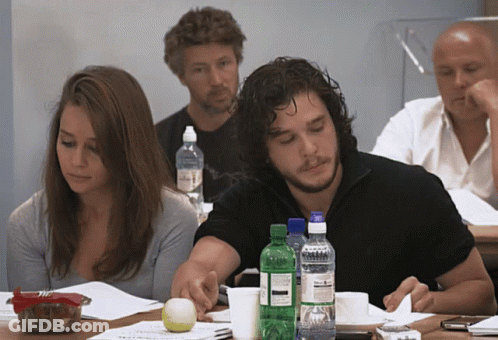 A Group Of People Are Sitting At A Table With Bottles Of Water Including One That Says Sprite GIF