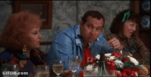 A Group Of People Are Sitting At A Table With Glasses Of Wine And Food . GIF