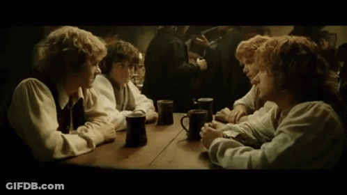 A Group Of People Are Sitting At A Table With Mugs Of Coffee . GIF