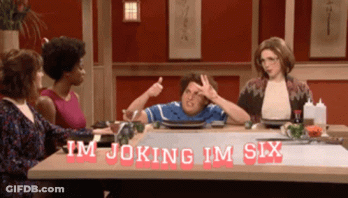 A Group Of People Are Sitting At A Table With The Words Im Joking Im Six Written On It GIF