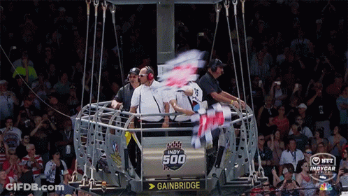 A Group Of People Are Sitting In A Cage That Says Gainbridge GIF