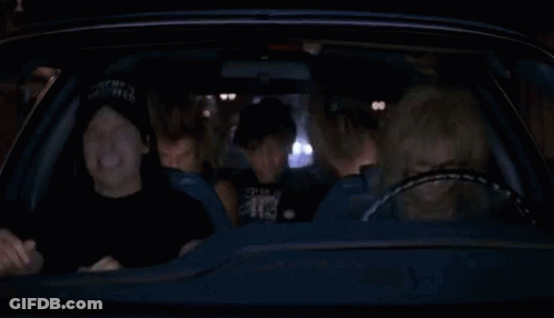 A Group Of People Are Sitting In A Car At Night And Laughing . GIF