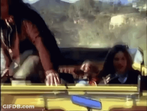 A Group Of People Are Sitting In A Car Looking Out The Window GIF