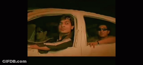 A Group Of People Are Sitting In A Car With Their Arms Out The Window . GIF