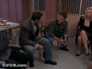 A Group Of People Are Sitting In A Circle And Talking GIF