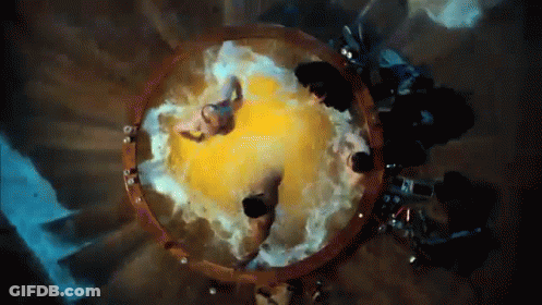 A Group Of People Are Sitting In A Circle With A Yellow Object In The Middle GIF