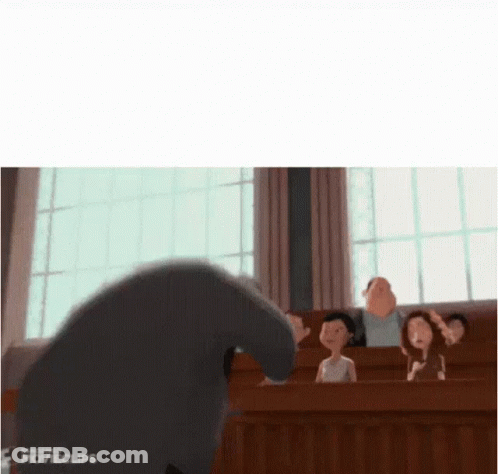 A Group Of People Are Sitting In A Classroom With A Cartoon Character Standing In Front Of Them . GIF