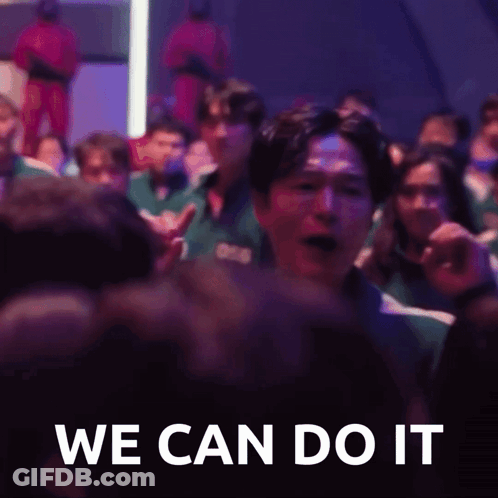 A Group Of People Are Sitting In A Dark Room And A Man Is Screaming In The Middle Of The Crowd . GIF