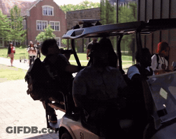 A Group Of People Are Sitting In A Golf Cart Numbered 31 GIF