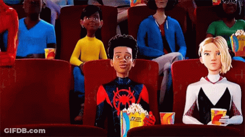 A Group Of People Are Sitting In A Movie Theater Watching A Movie . GIF