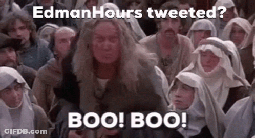 A Group Of People Are Sitting In A Room And A Woman Is Standing In Front Of Them . GIF