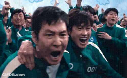 A Group Of People Are Sitting In A Room And Laughing . GIF