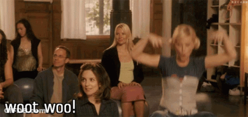 A Group Of People Are Sitting In A Room And One Of Them Is Saying Woot Woo . GIF