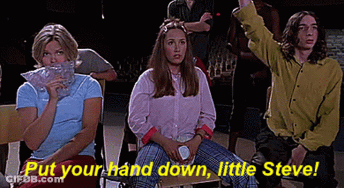 A Group Of People Are Sitting In A Room With The Words `` Put Your Hand Down , Little Steve '' . GIF