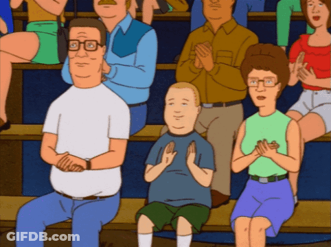 A Group Of People Are Sitting In A Stadium Clapping GIF