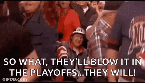 A Group Of People Are Sitting In A Stadium Watching A Game And A Man Is Sitting In The Stands . GIF