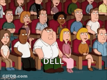 A Group Of People Are Sitting In A Theater And One Of Them Is Kneeling Down And Saying Dell GIF