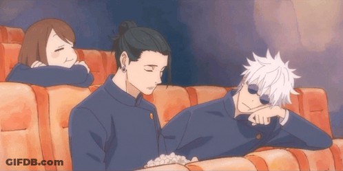 A Group Of People Are Sitting In A Theater Watching A Movie GIF