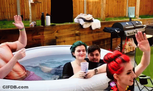 A Group Of People Are Sitting In An Inflatable Tub GIF