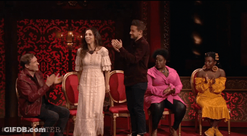 A Group Of People Are Sitting In Chairs And Applauding With The Hashtag Taskmaster On The Bottom GIF