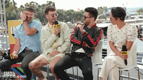 A Group Of People Are Sitting In Front Of A Microphone That Says Imdb GIF