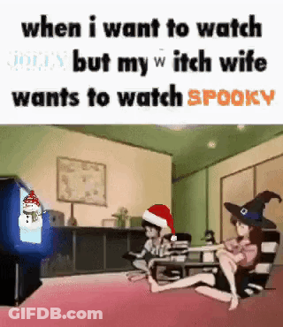 A Group Of People Are Sitting In Front Of A Television In A Living Room . One Of The People Is Wearing A Santa Hat . GIF