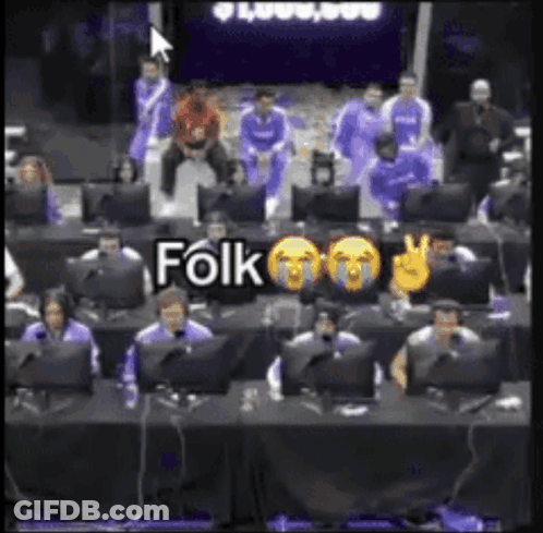 A Group Of People Are Sitting In Front Of Computer Monitors And A Sign That Says Folk On It GIF