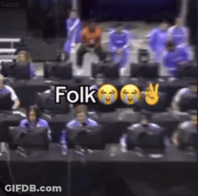 A Group Of People Are Sitting In Front Of Computer Monitors And A Sign That Says Folk GIF